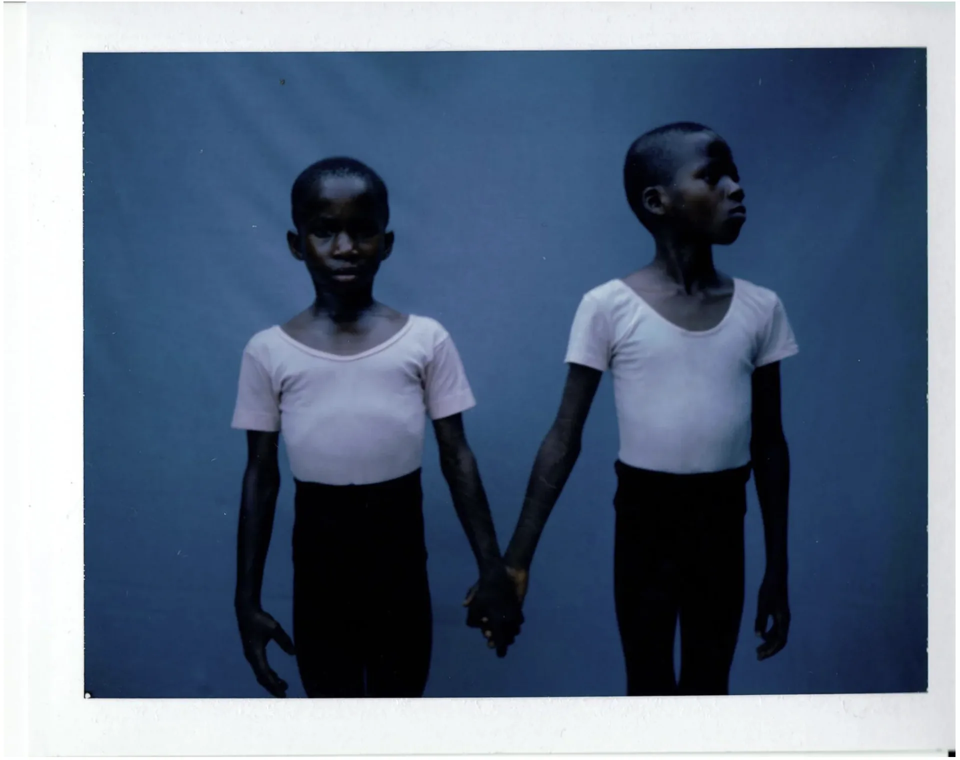 Ijó — young dancers holding hands, polaroid